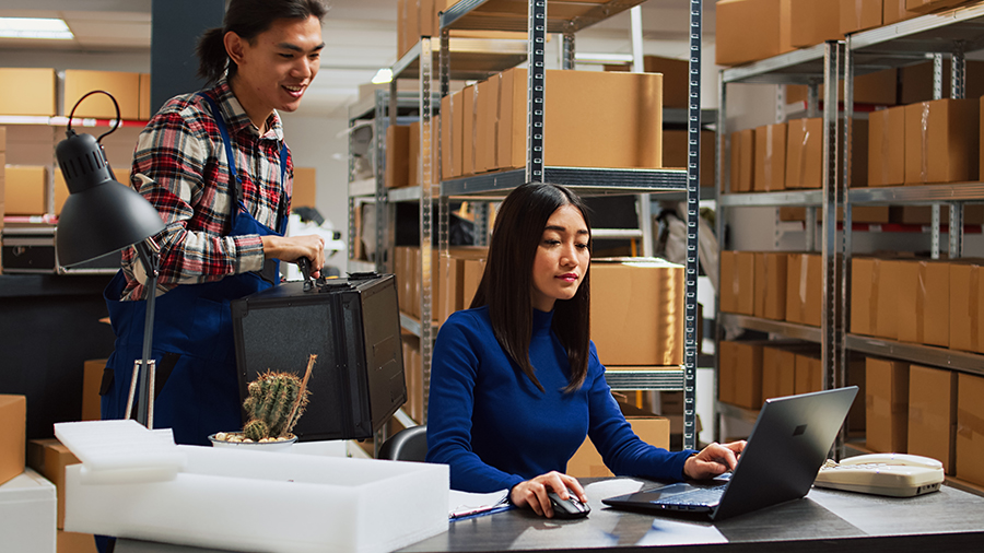 Asian team working on product inventory in warehouse